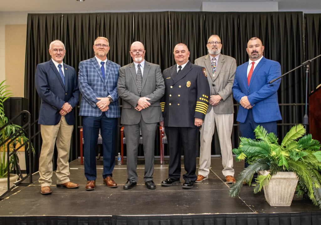 group on stage with firefighters 